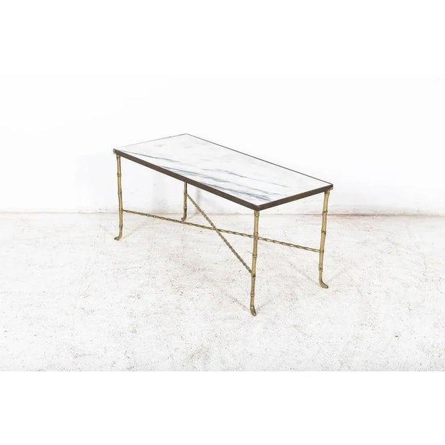 Antique Circa 1940 Brass Faux bamboo coffee table. Decorative faux bamboo coffee table attributed to Maison Bagues with...