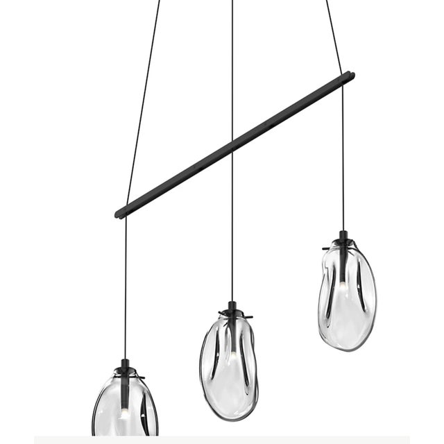The SONNEMAN Lighting Liquid 3-Light Linear Suspension is an innovative piece with artisan aesthetics. The glass form has...