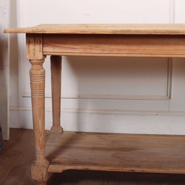 Large narrow French drapers/ console table in a natural light pine finish. 1890 52cm H between potboard and rail This...