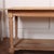 Large narrow French drapers/ console table in a natural light pine finish. 1890 52cm H between potboard and rail This...