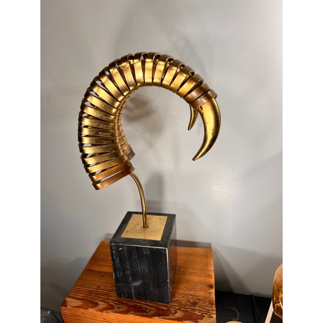 Brass Ram Horns by Curtis Jere no signed but there is a sticker at the bottom of the base made of marble . Looks more...