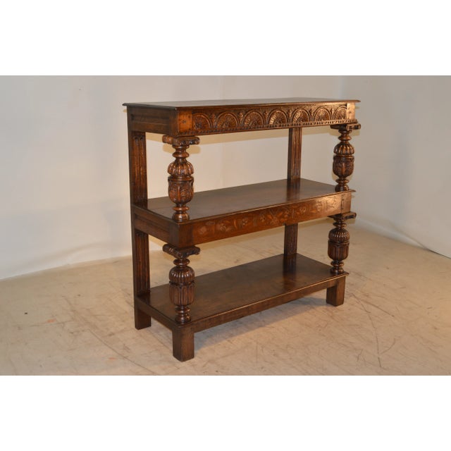 19th century English oak buffet which is unusual due to the inlaid designs. It has three shelves, which are separated by...