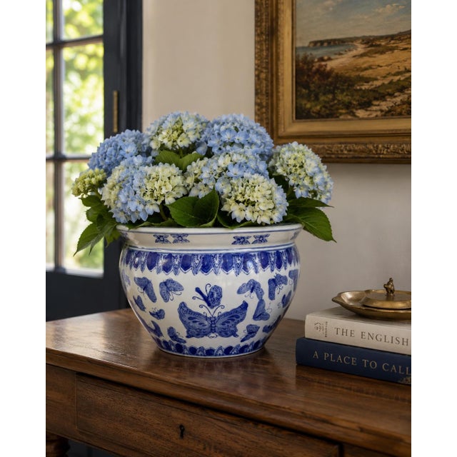 A classic blue and white porcelain fishbowl planter, that feels both tailored and relaxed. The hand-painted botanical and...