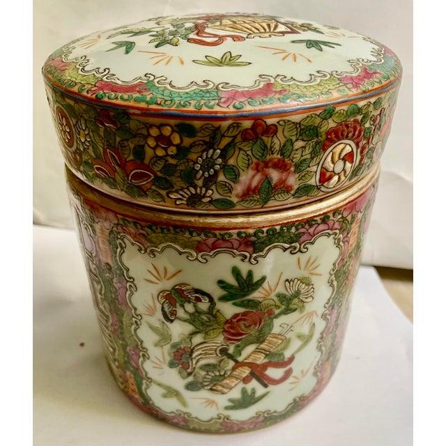 This is a classic style Chinese Export covered jar/box with alternating panels of a scene on steps and a botanical and...