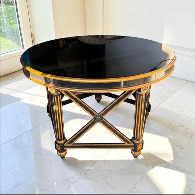 Neo-Classical style "Quince" accent or foyer table designed by Maitland-Smith. Key Features • Design: Features an ebonized...