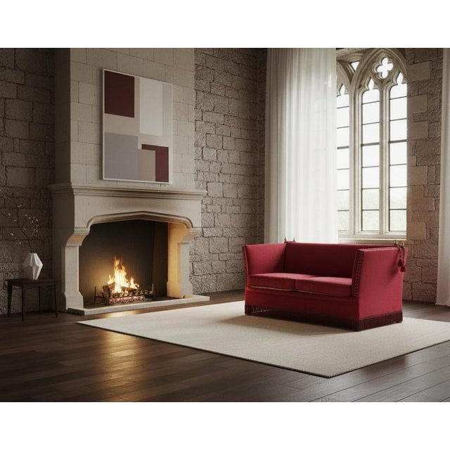 A beautiful example of the traditional Knole sofa, featuring rich red velvet upholstery and floral-patterned, reversible...