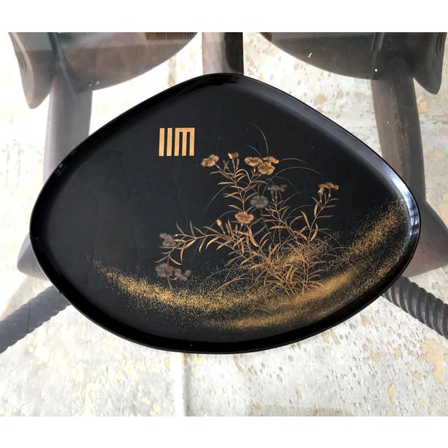 A fan shape black lacquer tray from Japan circa 1910-30s, late Meiji to early Showa era. Elaborated decorated with a...