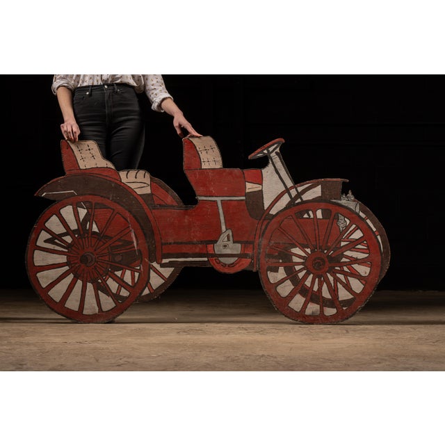 Antique, hand-painted early automobile sign. This piece depicts a turn-of-the-century motor carriage in the style of...
