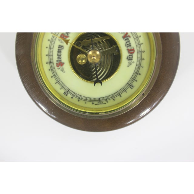 This is a charming and very interesting vintage barometer made in Western Germany. It is made of dark wood, brass and...