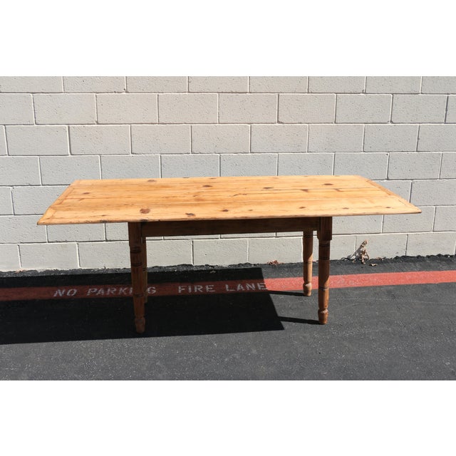 Beautiful 19th-century French Provincial farmhouse drop-leaf dining table, crafted from solid pine and featuring classic...