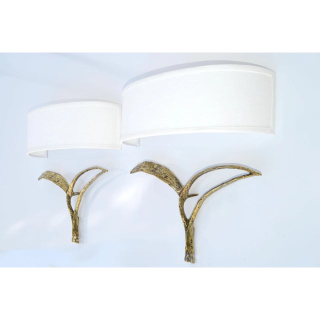 Pair of Bronze Sconces, Essor Model , Wall Lights with Ivory Fabric Half-Shield Shades designed by Félix Agostini in...