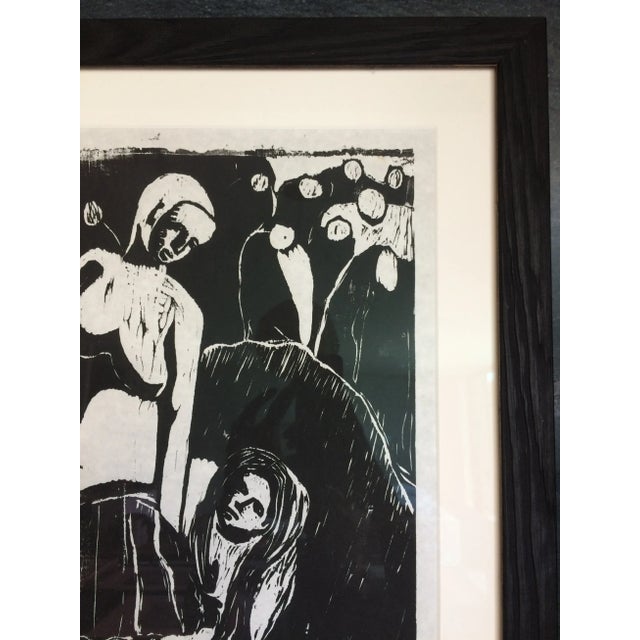 Rich black and white woodcut print in a new black stained wood frame. Wood frame has a textured grain. In perfect...