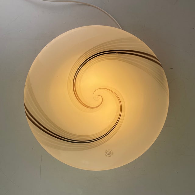 Flush-mount light made of a white Murano glass diffuser with black & grey swirl stripes on a white metal base. Produced in...