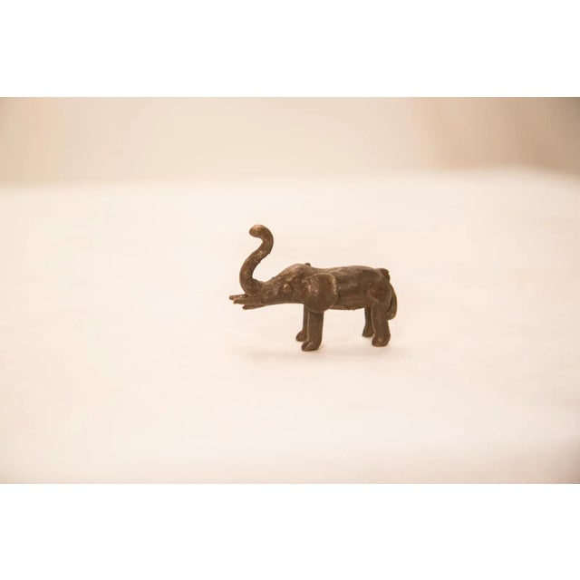 :: Vintage handmade bronze African sculpture of a elephant with dark iron-like patina. Circa mid 20th century and possibly...