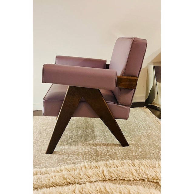 This striking Italian-made armchair features a bold, architectural silhouette paired with luxurious materials and...