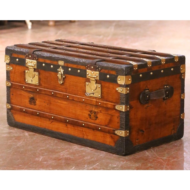 This handsome antique French travel trunk was crafted in Paris in the late 19th century and bears its original brass...
