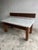This striking postmodern console table combines the timeless elegance of white marble with the warmth of richly grained...