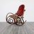 This charming rocking chair is attributed to Thonet, a representative example of mid-century design. Made of steam-bent...