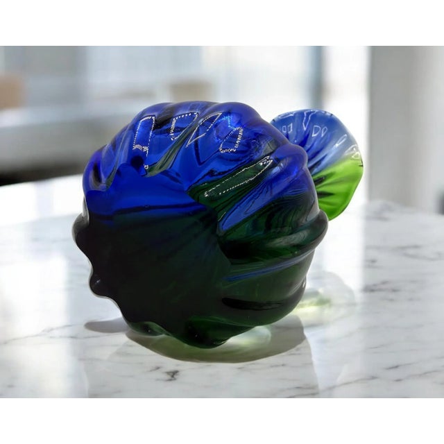 A refined example of Venetian artistic glass: this blown Murano glass vase features vibrant shades from deep blue to...
