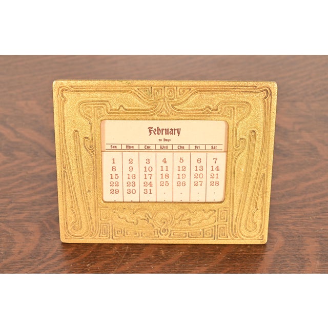 A gorgeous antique Art Deco period "Chinese" pattern gilt bronze desk calendar frame or picture frame By Tiffany Studios...