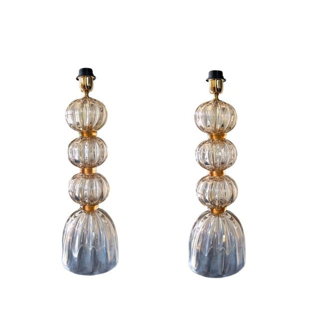 An elegant pair of modern Murano glass bubble lamps, artisan made in Murano, Italy, showcasing a refined sculptural...