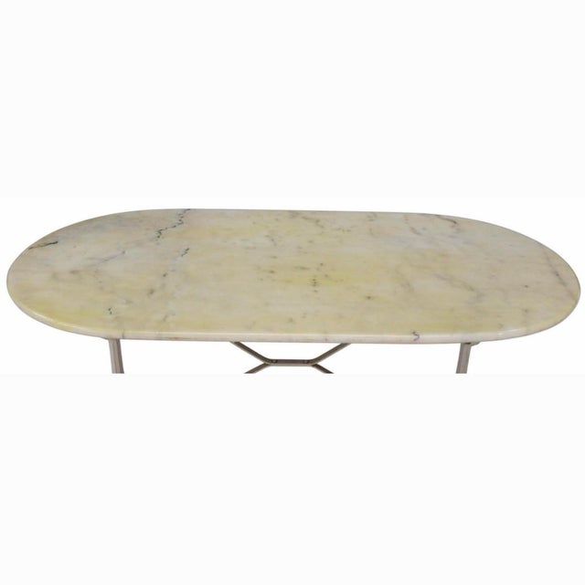 Parisian bistro table, 20th century, oval marble top over a white painted cast iron base with a cross stretcher Height:...