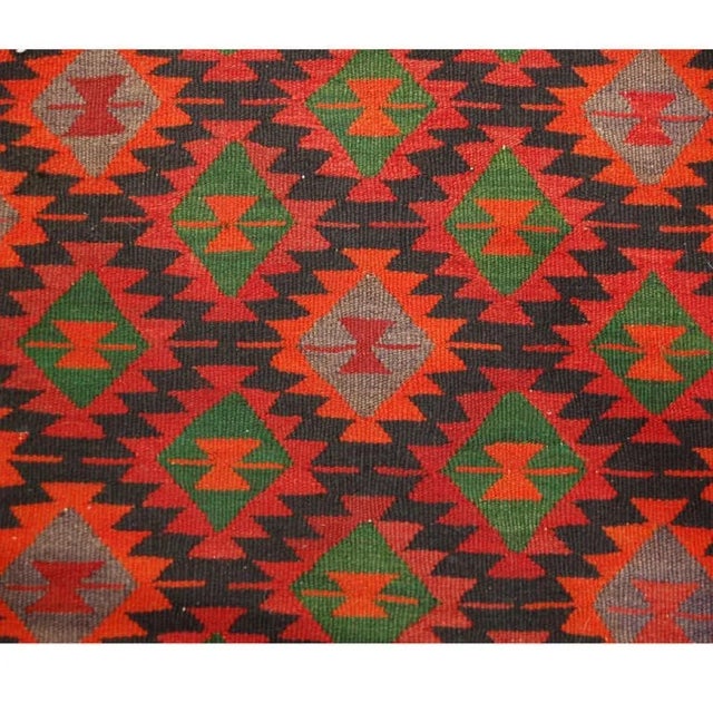 An early 20th Century, century 1930s, Qazvin Kilim runner with all-over brilliant crimson, emerald and orange geometric...