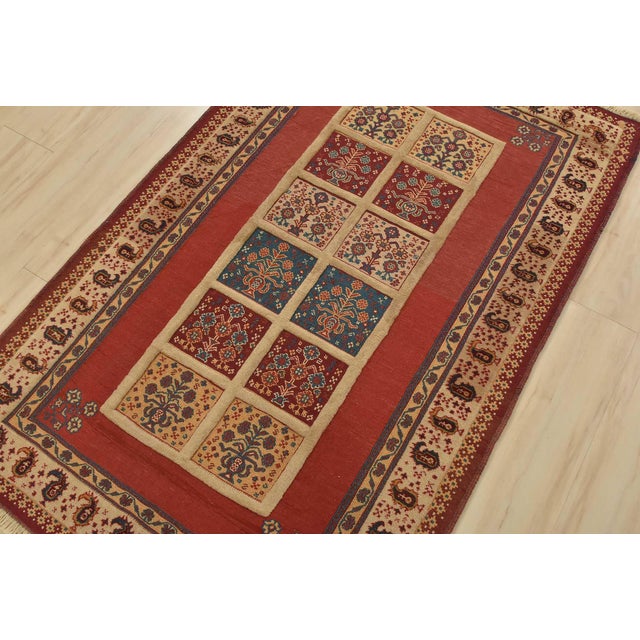 An authentic vintage tribal Gabbeh rug hand-knotted with fine wool and natural dyes. This finely woven rug features a...