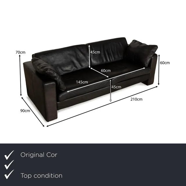 The Conseta sofa by Cor is upholstered in black leather and features floor-to-ceiling sides. Its classic, comfortable...