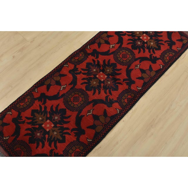 An authentic tribal Turkmen runner hand-knotted with an all-wool pile on a cotton foundation. This oriental rug features a...