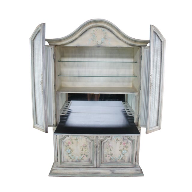 Vintage Wellington Hall dry bar cabinet / armoire featuring French Provincial styling with hand painted floral and ribbon...