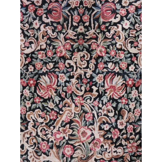 This mid-20th-century Persian Kashan room-size carpet presents an elaborate allover floral composition across a deep navy...