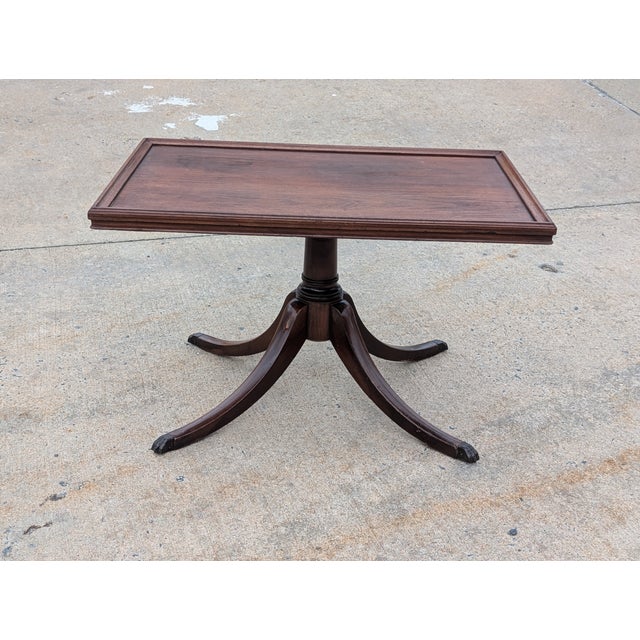 Elevate your living space with this sophisticated Georgian-style mahogany cocktail table. Crafted with a deep, rich...