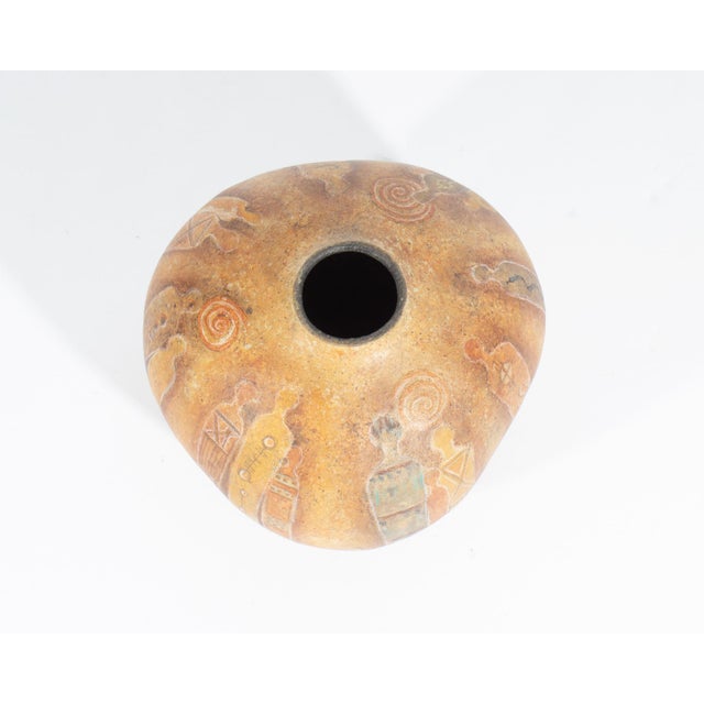A 1996 hand-painted gourd vase by American artist Jolee Schlea. This gourd features abstract figures with various...