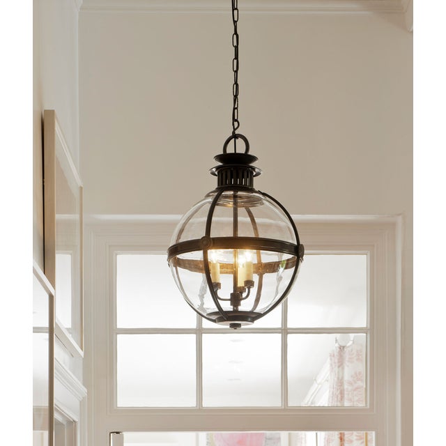 Inspired by a 19th century antique, this globe ceiling light has three lights. The hand-blown glass sphere emanates...