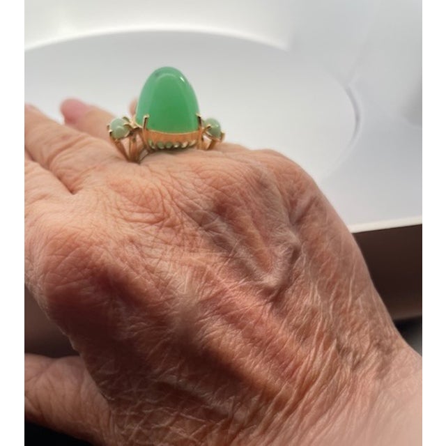 "This one-of-a-kind Chrysoprase Bullet Ring is crafted in 14K yellow gold, featuring a breathtaking 34-carat center stone...