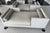 Beautiful matched pair of custom A. Rudin No. 2725 tête-à-tête sofas upholstered in a refined neutral palette. The double-...