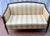 Description: Elevate your space with this stunning late 20th Century Federal style mahogany settee, meticulously crafted...