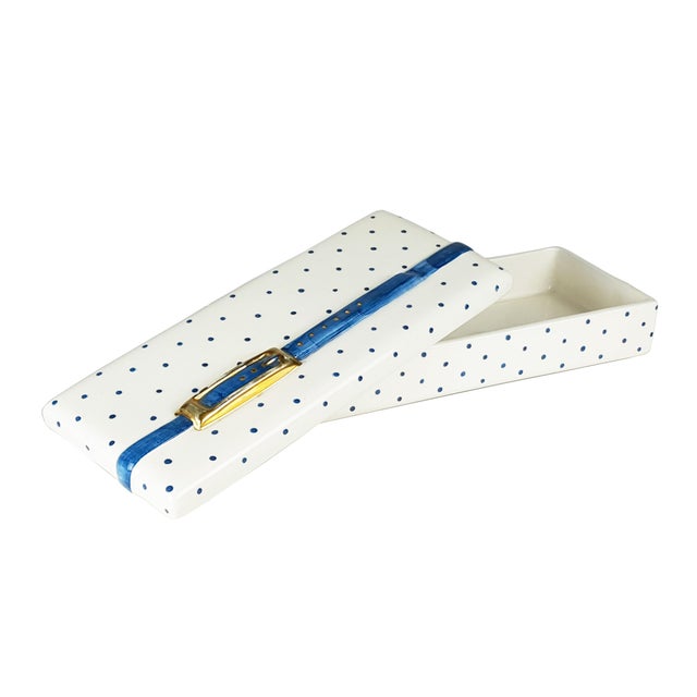 This vintage box is made from hand painted and gilt ceramic with a pois and strap relief decoration. it was designed and...