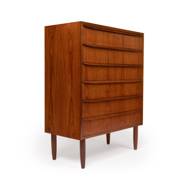 This stunning 1960s Danish Mid-Century teak tallboy dresser is a timeless piece of craftsmanship. Featuring exquisite wood...