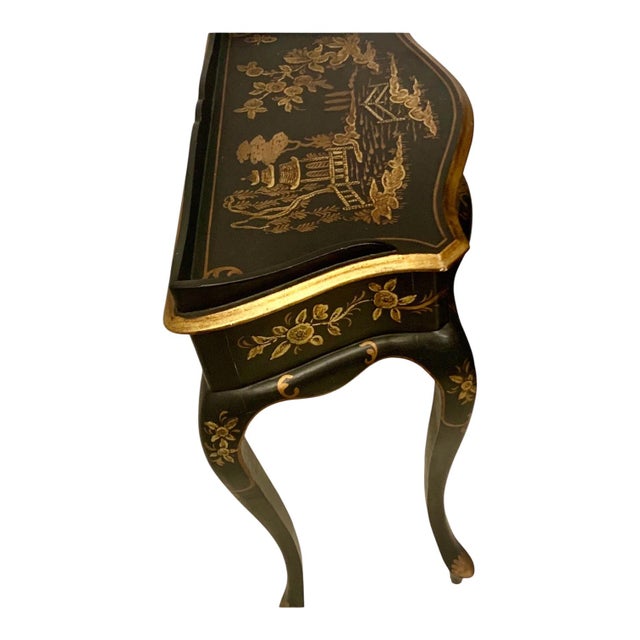 This is a wonderful hand painted Italian side table with a handy single drawer. It has ablack lacquer foundation with gilt...