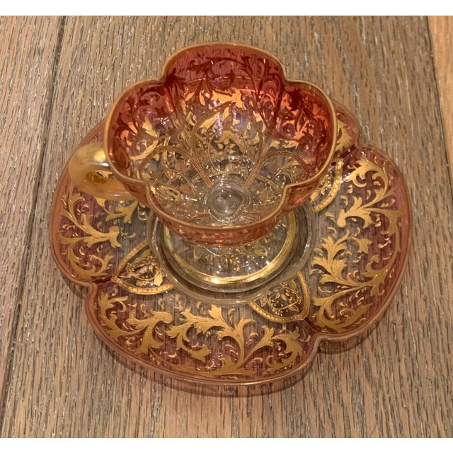 Eastern European ombre glass cup and saucer. The rose colored set is a subtle clover shape and heavily embellished with...
