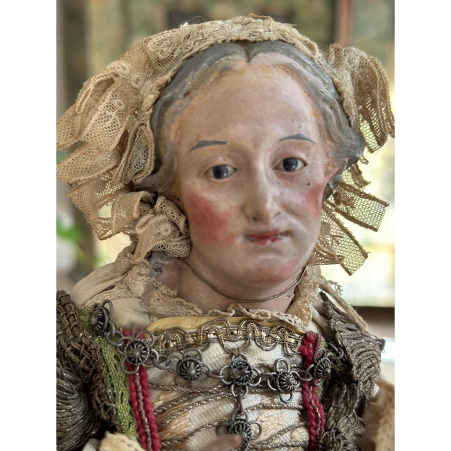 This rare, antique Neapolitan nativity figure from the 18th century represents a woman in traditional dress with a...