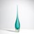 Introducing our flute vase in a tranquil teal; a masterpiece of artisanal glasswork that exudes elegance and...