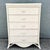 A charming vintage boho chic highboy dresser crafted in woven wicker with a soft, whitewashed finish. Featuring five...