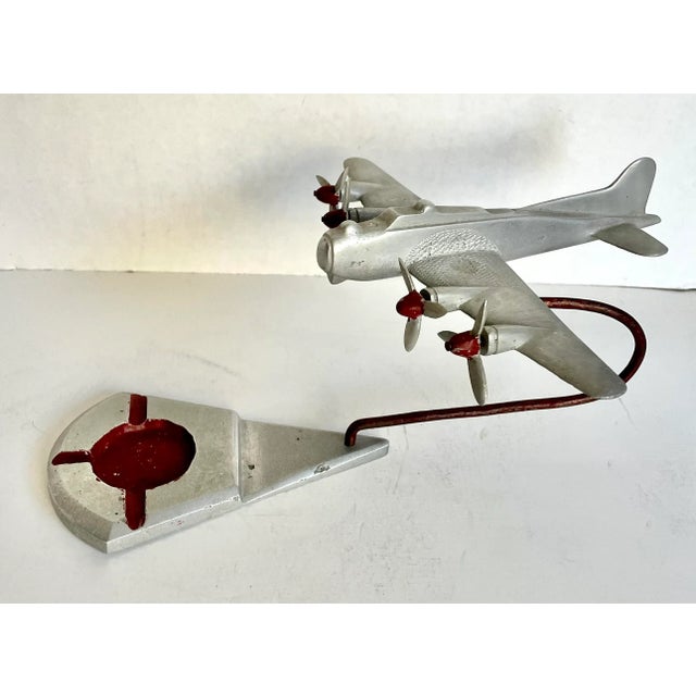 Here is a wonderful piece of history! There are 3 pieces here that together shape an airplane in flight over a diamond...