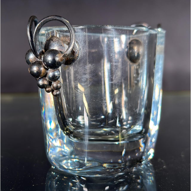 This diminutive cut crystal vase by Strömbergshyttan of Sweden is fitted with a pair of sterling silver handles in the...
