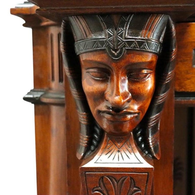 An exceptional antique Victorian Egyptian Revival secretary desk, crafted from carved walnut with striking gilt and...