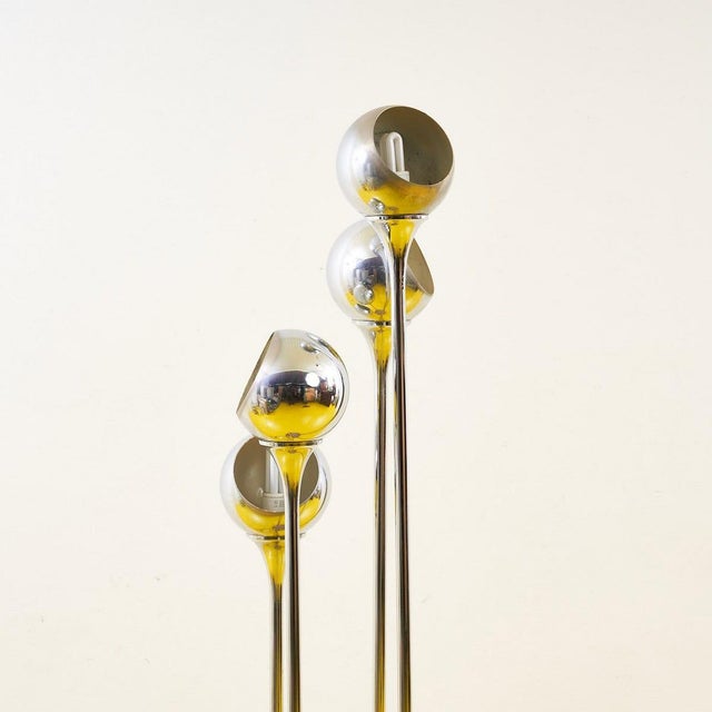 This charming floor lamp combines elegance and functionality, making it an objet d'art for your home. With three slender...