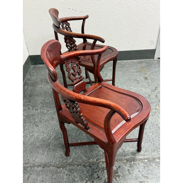 Design Plus Gallery presents a Pair of Vintage Rosewood Corner Chairs. Expertly handcrafted from solid rosewood, this...